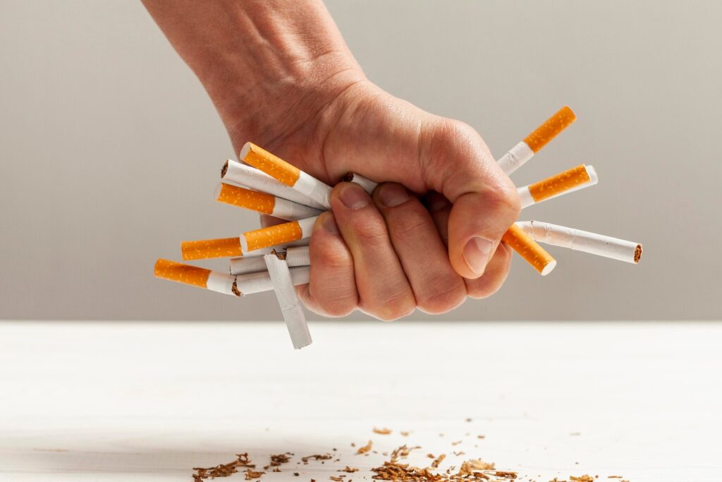 تاثیر نیکوتین بر مغز و اعصاب با نمایش چند سیگار مچاله شده در دست یک فرد